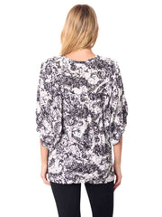 Woman wearing a black and white patterned Cotton blouse 