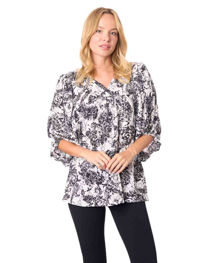 Woman wearing a black and white patterned Cotton blouse 