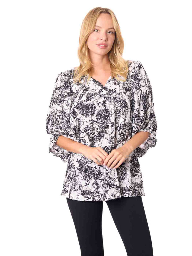 Woman wearing a black and white patterned Cotton blouse 