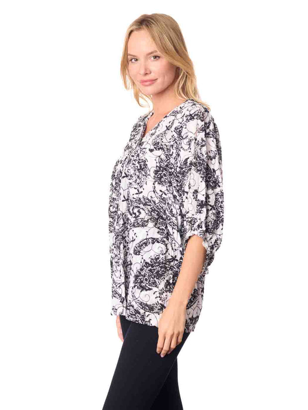 Woman wearing a black and white patterned Cotton blouse 