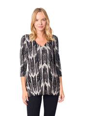 Woman wearing a black and white patterned top