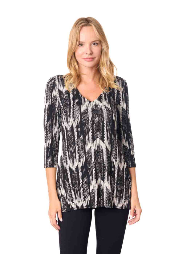 Woman wearing a black and white patterned top