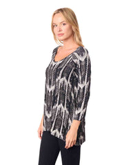 Woman wearing a black and white patterned top
