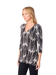 Woman wearing a black and white patterned top