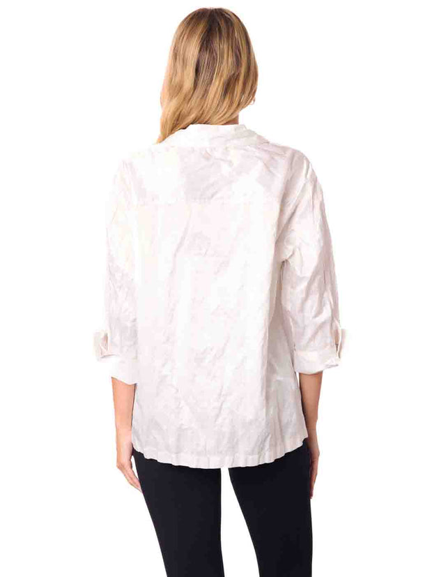 Woman wearing a white blouse and black pants