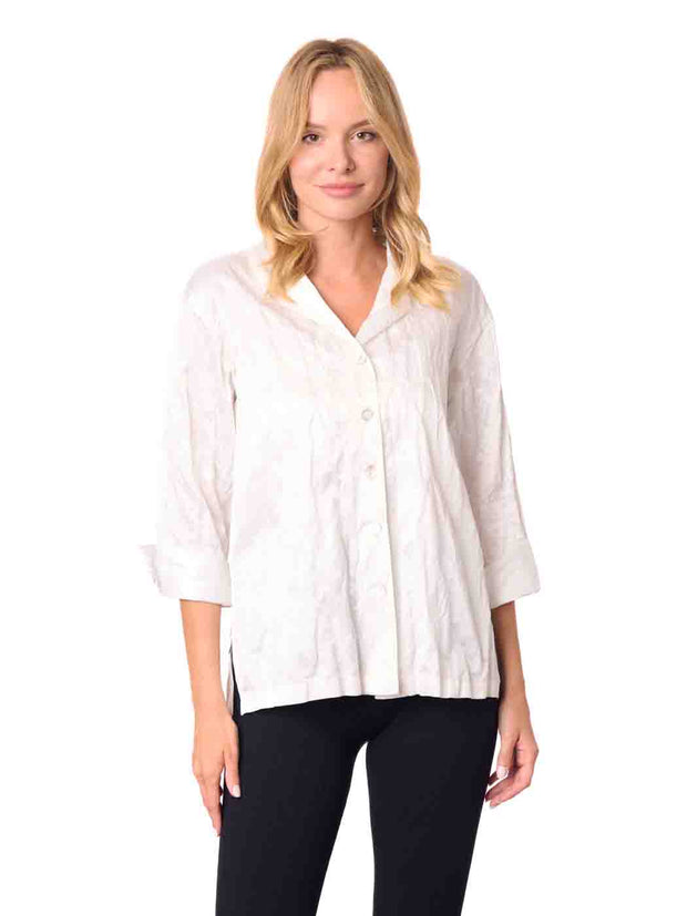 Woman wearing a white blouse and black pants